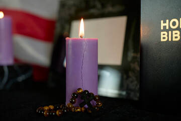 funeral an American hero, photo frame, candles, marble urn for ashes, holy bible and spiritual bracelet with black cross