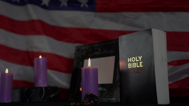     funeral of an American hero, photo frame, candles, a marble urn for ashes, holy bible and spiritual bracelet with black cross