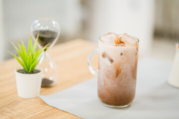 Iced cocoa in clear glass on table.