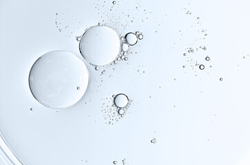 The texture of a cosmetic serum or body gel in a Petri dish.