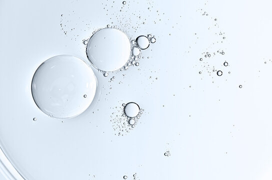 The texture of a cosmetic serum or body gel in a Petri dish.