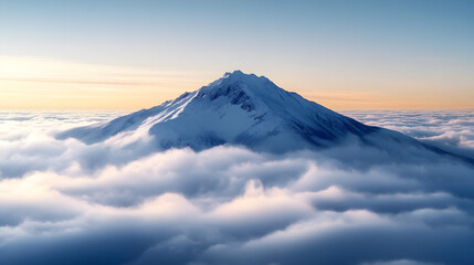 Naklejka premium Snowy mountain peak rising above the clouds.