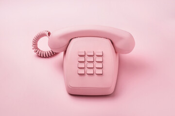 Retro pink telephone on pastel background. 80s or 90s retro fashion aesthetic telephone concept.