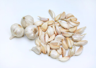Garlic cloves and bulb on white background close-up.
