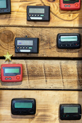 Different vintage pagers on a wooden background. Place for text