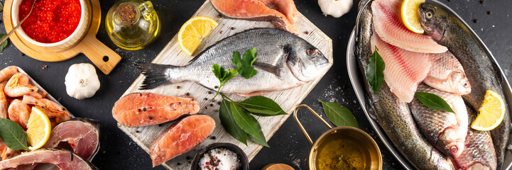 Variety raw fish and seafood background. Fresh fish, shrimps, mussels, caviar assortment flat lay, fish sale and market template