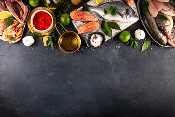 Variety raw fish and seafood background. Fresh fish, shrimps, mussels, caviar assortment flat lay, fish sale and market template