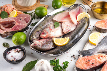 Variety raw fish and seafood background. Fresh fish, shrimps, mussels, caviar assortment flat lay,...