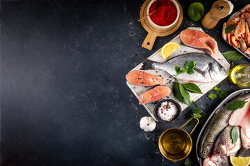 Variety raw fish and seafood background. Fresh fish, shrimps, mussels, caviar assortment flat lay, fish sale and market template