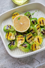 Roasted Brussels sprouts with lemon, vertical shot, selective focus, middle close-up