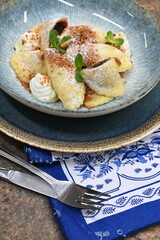 traditional european sweet dish varieniki pastries with blueberries, sweet lunch served food on a plate in a restaurant