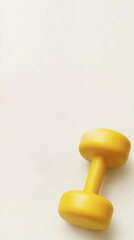 Minimalist fitness theme with overhead view of yellow dumbbell for gym design