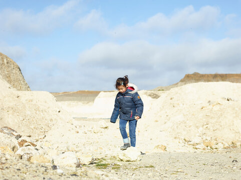 little girl play with a rock