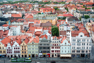 Fototapeta premium Green tram passing through Republic Square in Plzen (Pilsen), Czech Republic