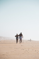 Beautiful couple walking on the beach