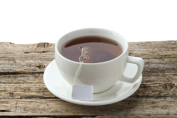 Tea bag in cup with hot drink on wooden table against white background