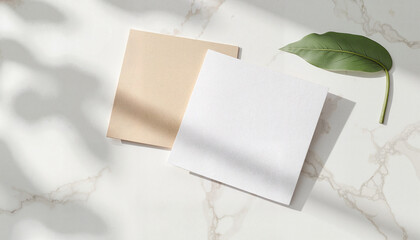 Fototapeta premium Blank beige and white paper sheets on marble background