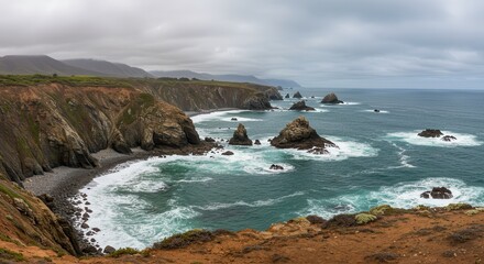 Dramatic Ocean Coastline with Sea Stacks and Waves Under Cloudy Sky