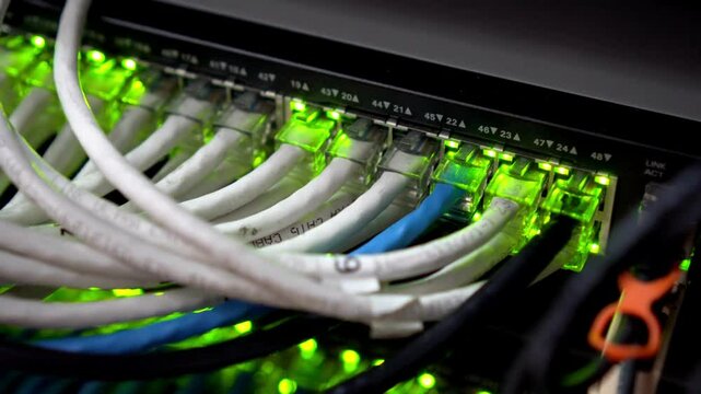 network server room server rack with fiber optic cables attached to front panel switch ports