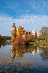 Schloss Muskau, Muskau palace, Saxony, Germany. UNESCO World Heritage Site. Autumnal landscape at the Prince Pückler Park, Bad Muskau. Palace on the lake. Reflection in water