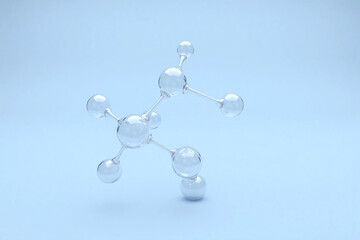 Molecular structure of spheres and bonds on blue background