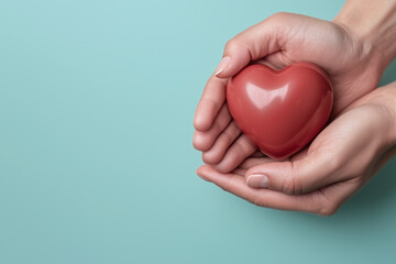 Obraz premium Caring hands holding red heart symbolizing love and compassion, conveying warmth and emotional connection, perfect for healthcare or wellness themes