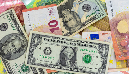 Paper bills of various denominations, euros and dollars, scattered, top view