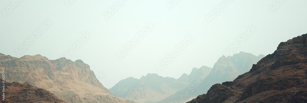 Aufkleber stunning panoramic view of a mountain range, showcasing layers of peaks fading into the misty distan