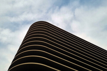 Modern Architectural Curves Against a Cloudy Sky - Perfect for Design and Print