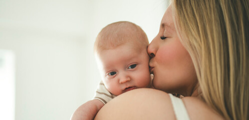 Cute small 1 month baby boy at home. Mother with little newborn infant.