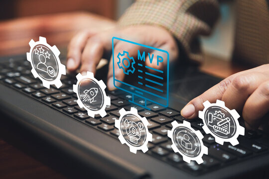 A business person types on a keyboard with a digital overlay of "MVP" and business-related icons, symbolizing the Minimum Viable Product approach in budget planning and iterative development