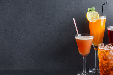 Refreshing drinks and beverages, cold and enticing on simple dark background