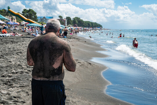 UREKI, GEORGIA - AUGUST 22, 2023:  Man on the beach with black sand.