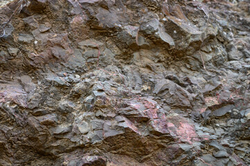 Textured rock formation reveals layers of history in a serene natural landscape