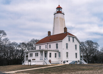 Sandy Hook Lighthouse in Winter – Historic New Jersey Landmark Under a Cloudy Sky..