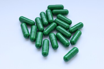 green pills on white background
