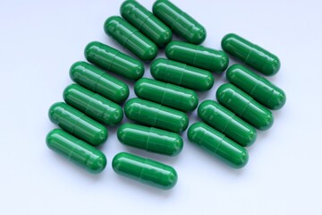 green pills on white background