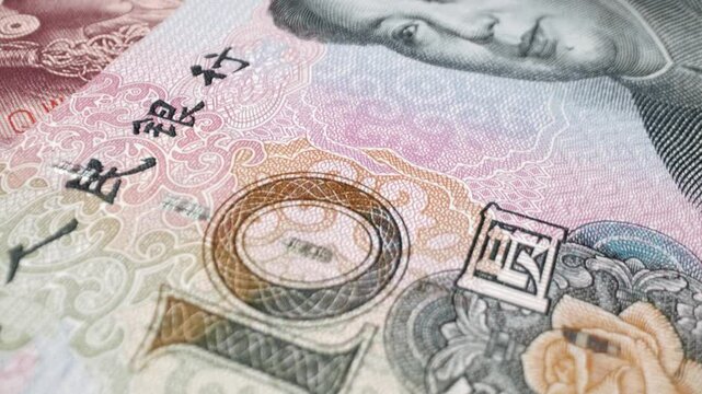 Extreme macro shot of a 10 Chinese yuan banknote with a sliding motion.