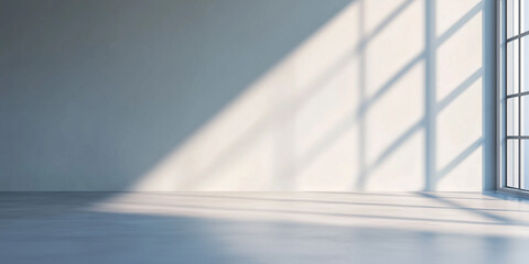 Obraz premium bright, empty room with sunlight casting shadows on floor and walls, creating serene atmosphere.