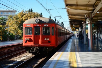 Red Train at Station Platform Cityscape