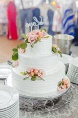 White wedding cake with whipped cream and fruit, wedding food, traditional piled cake