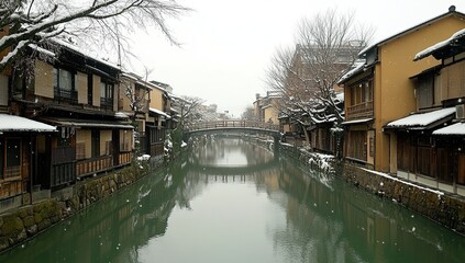 Obraz premium A photo of the snow-covered Gion-bashi town in Japan, featuring traditional wooden buildings and stone