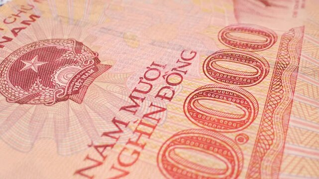 Macro shot of a Vietnamese 50,000-dong banknote with a sliding motion.