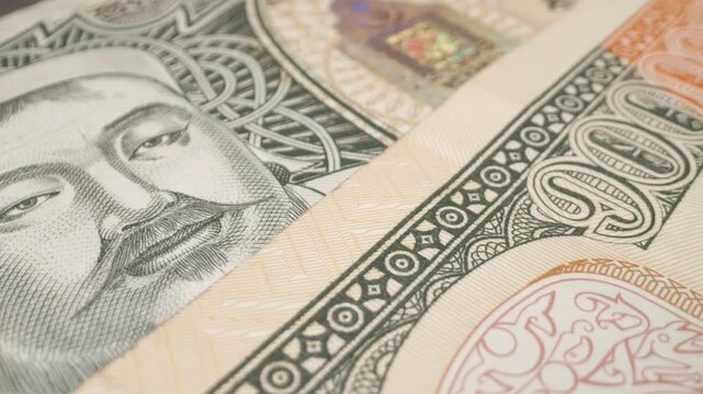 Macro shot of a Mongolian 10,000-tugrik banknote with a sliding motion.