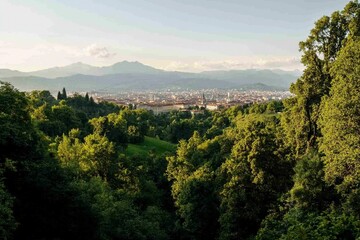 Fototapeta premium Panoramic view of city nestled in valley, mountains in background. Ideal for travel or nature photography