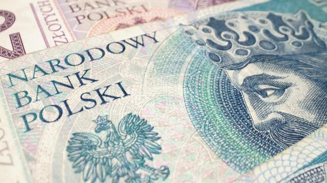  A close-up macro shot of Polish zloty banknotes with a sliding motion