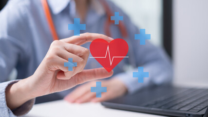 Professional healthcare medical worker holding red heart with cardiogram cardiologist concept