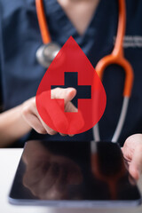 Professional health care worker doctor physician holding blood icon for blood donation concept