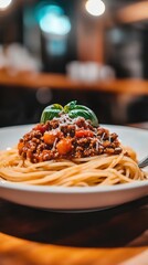 spaghetti bolognese with tomato sauce and basil on plate