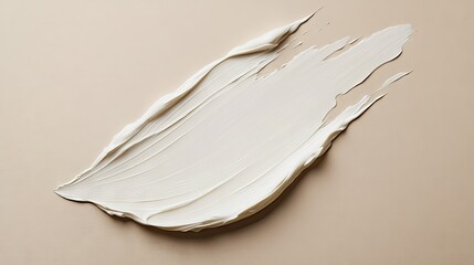 A soft white beauty cream stain on a beige background, captured from above to highlight its luxurious texture.